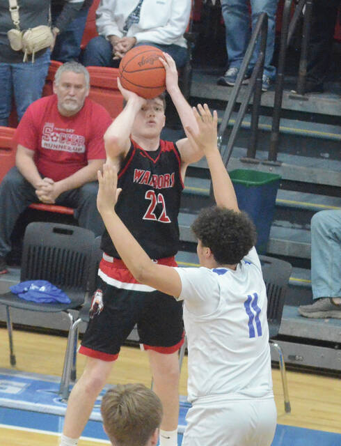 Easterns Carter Cluxton drains a three-pointer during the Warriors Feb. 19 win at Ripley. Photo by Wade Linville